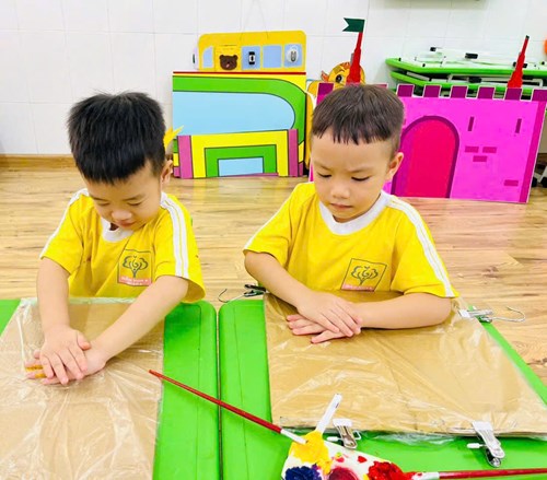 Các bé lớp Sơn Ca 1 (Mẫu giáo 4 - 5 tuổi) trong một giờ hoạt động tạo hình trang trí tạp dề.